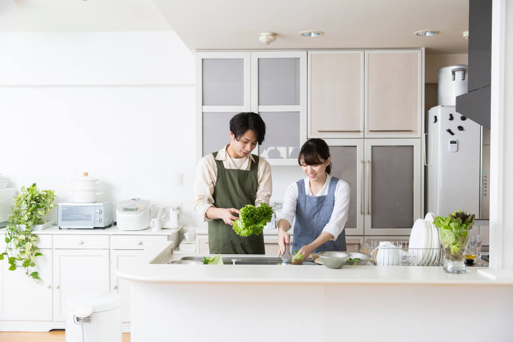 キッチンで食事を作るカップル