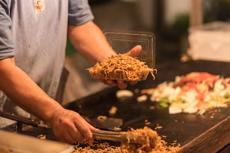夏祭りの屋台　焼きそばを作る人クローズアップ